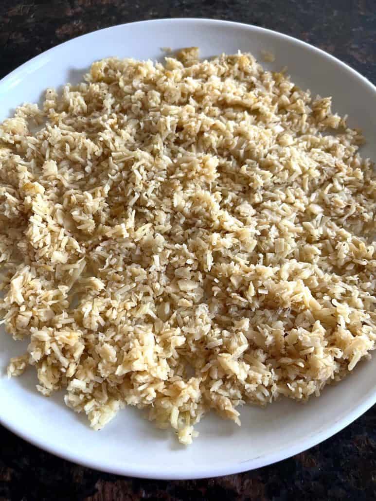 Plated hearts of palm rice served on a white dish – a quick and healthy low-carb rice alternative perfect as a side or base for meals.