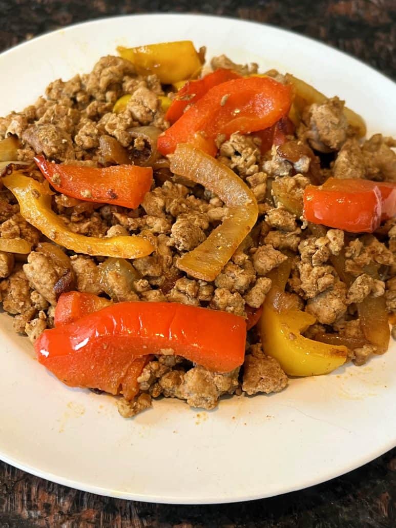 Served plate of ground turkey fajitas with sautéed onions and bell peppers.