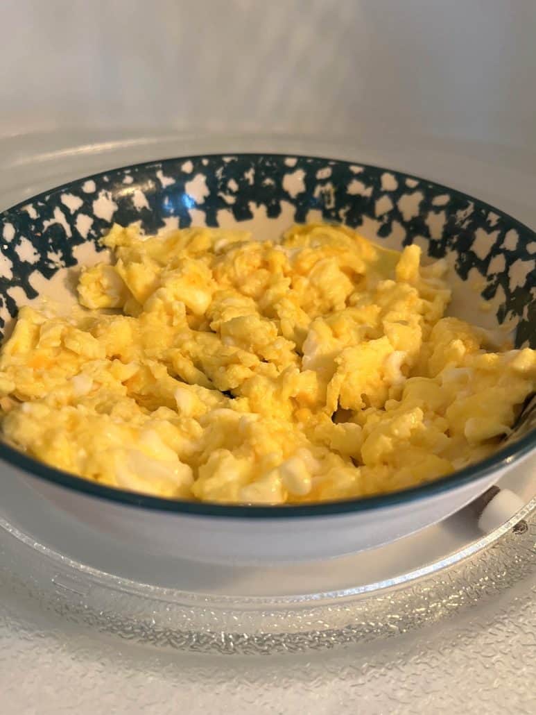 Fluffy scrambled eggs cooked in the microwave, served in a patterned bowl for a quick and easy breakfast.