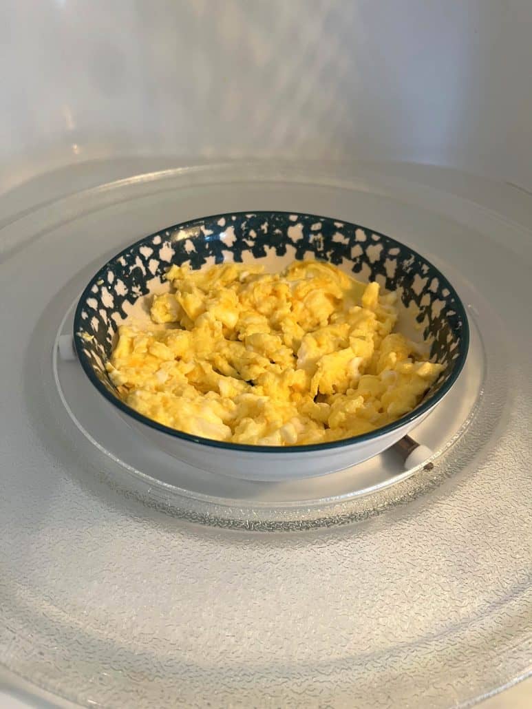 Close-up of fluffy scrambled eggs freshly cooked in the microwave, showing how easy and quick this method is.