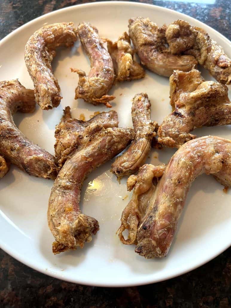 Close-up of cooked chicken necks served on a white plate, showcasing their crispy texture from the Air Fryer Chicken Necks recipe.