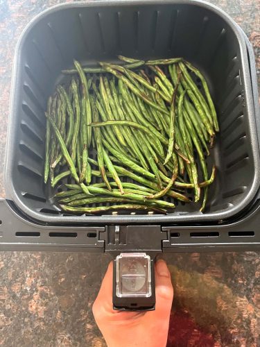 Fresh French green beans (Haricot Verts) placed in an air fryer basket, ready to be cooked for the Air Fryer French Green Beans recipe.