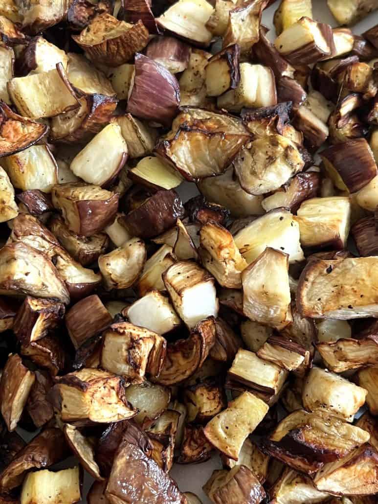Close-up of crispy, golden graffiti eggplant cubes, freshly air fried and ready to serve.
