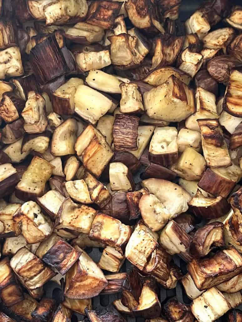 Close-up of crispy, roasted graffiti eggplant cubes fresh from the air fryer, highlighting the delicious texture.