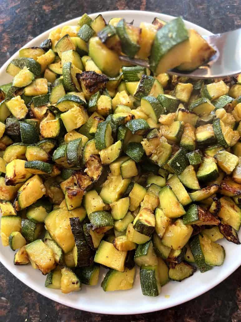 Air fried Lita squash served on a plate with a spoon, ready to be dished out as a healthy side.
