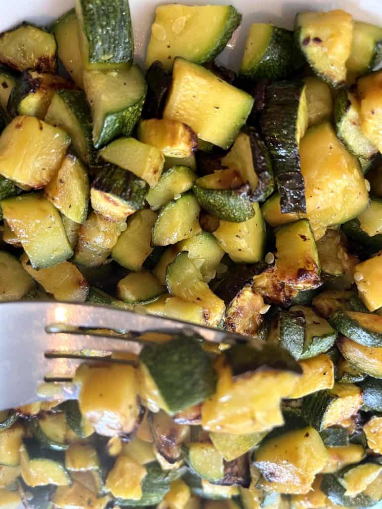 Close-up of forkful of crispy air fried Lita squash, showing golden brown edges and tender texture.