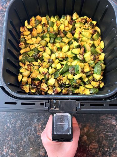 Cooked air fryer Lita squash in basket, crispy and golden after 20 minutes at 400°F".