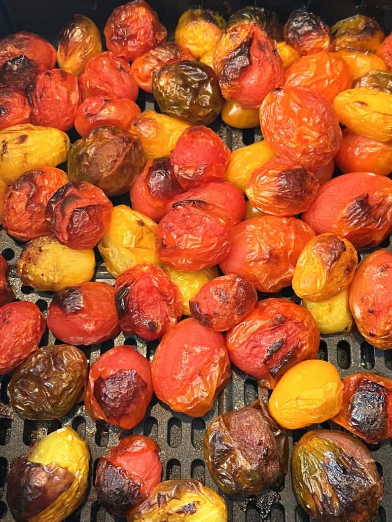 Close-up of blistered and caramelized medley tomatoes fresh from the air fryer, highlighting the rich texture and color.
