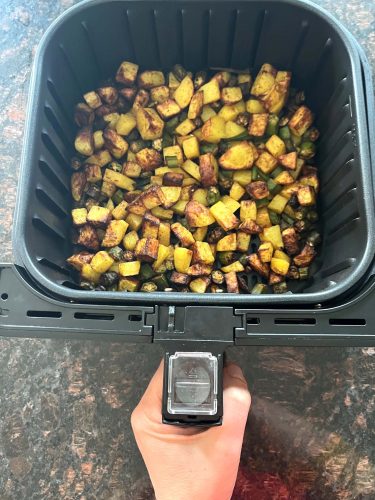 Crispy air fryer okra and potatoes fresh out of the basket, perfectly browned and ready to serve as a flavorful, healthy side dish.