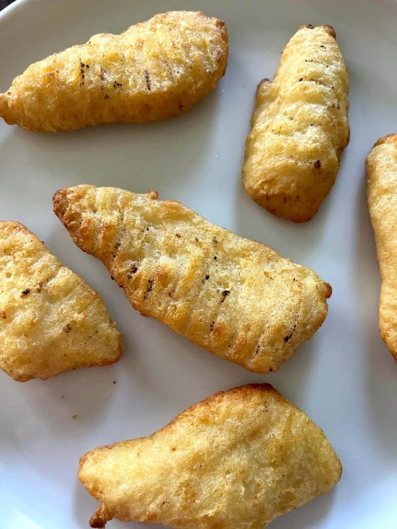 Close-up of Golden, crispy Trader Joe’s battered halibut fillets served on a plate.