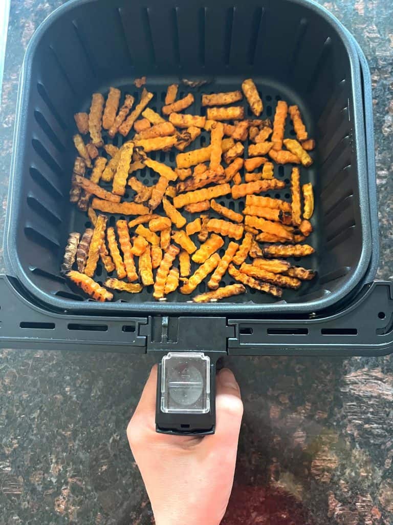 Air fryer basket filled with cooked Trader Joe’s Butternut Squash Zig-Zags, freshly crisped and ready to serve as a healthy alternative to fries.