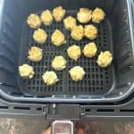 Frozen Trader Joe’s Chicken Shu Mai dumplings arranged in a single layer inside an air fryer basket.
