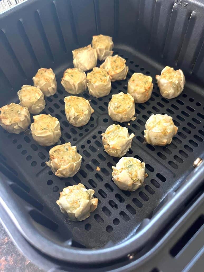 Crispy, golden Trader Joe’s Chicken Shu Mai dumplings freshly cooked in the air fryer basket.