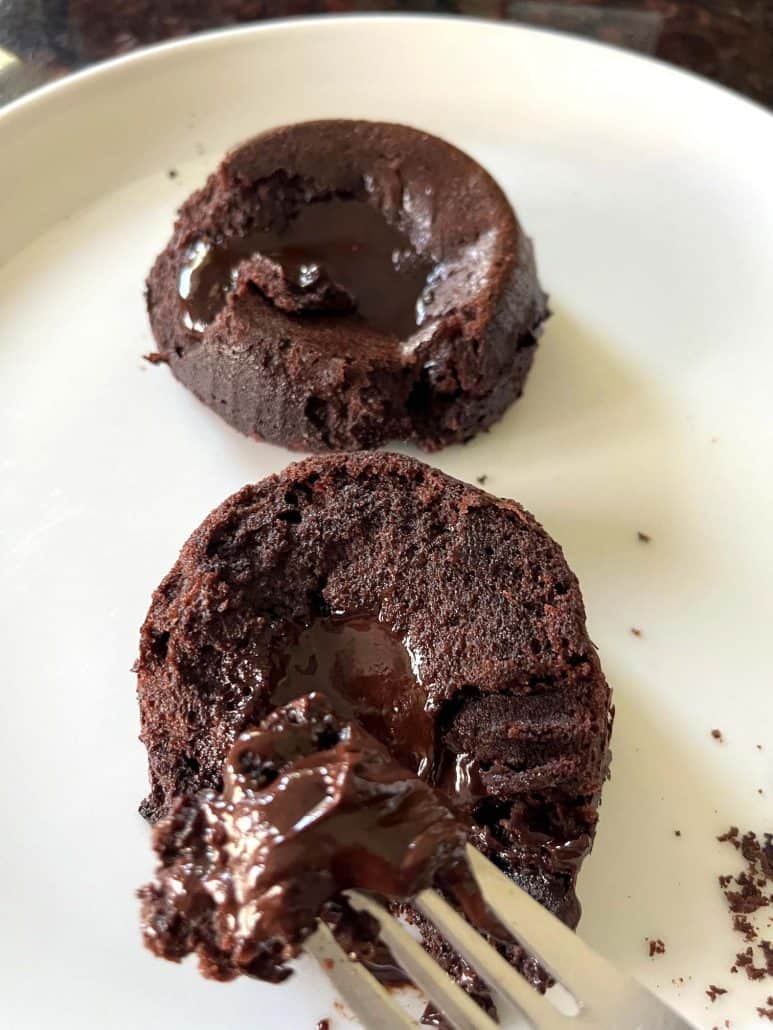 Melting chocolate oozing from a Trader Joe’s lava cake as a fork lifts a bite, capturing the gooey center and rich texture.