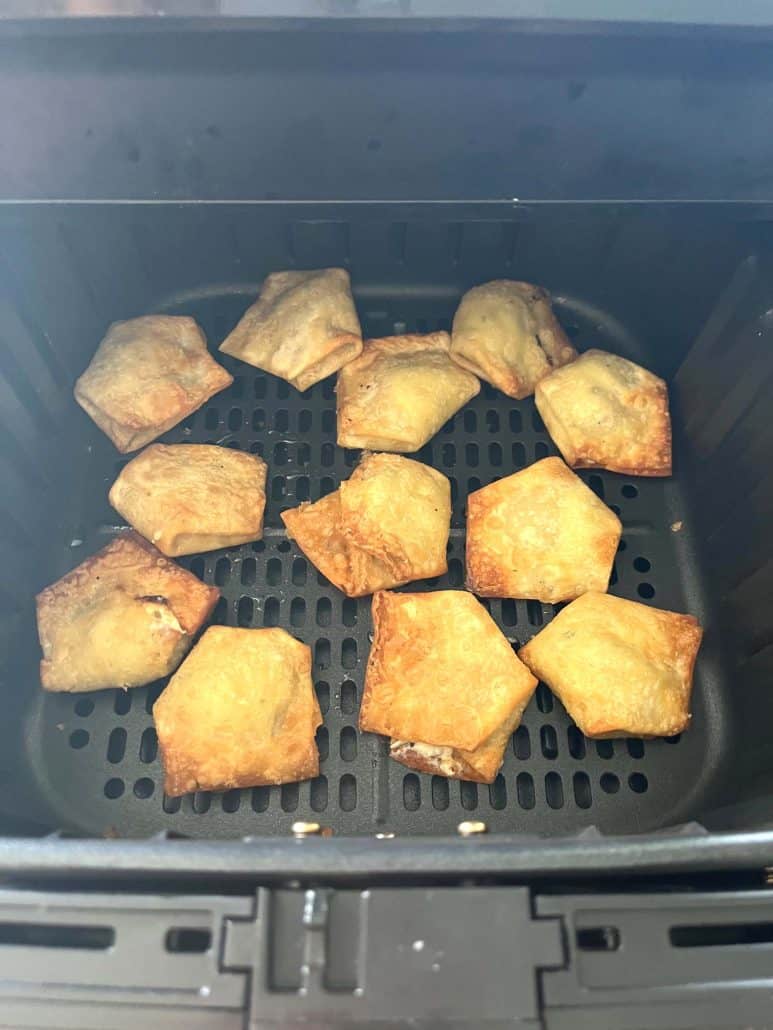 Close-up of crispy Trader Joe’s wontons inside the air fryer basket, perfectly cooked.