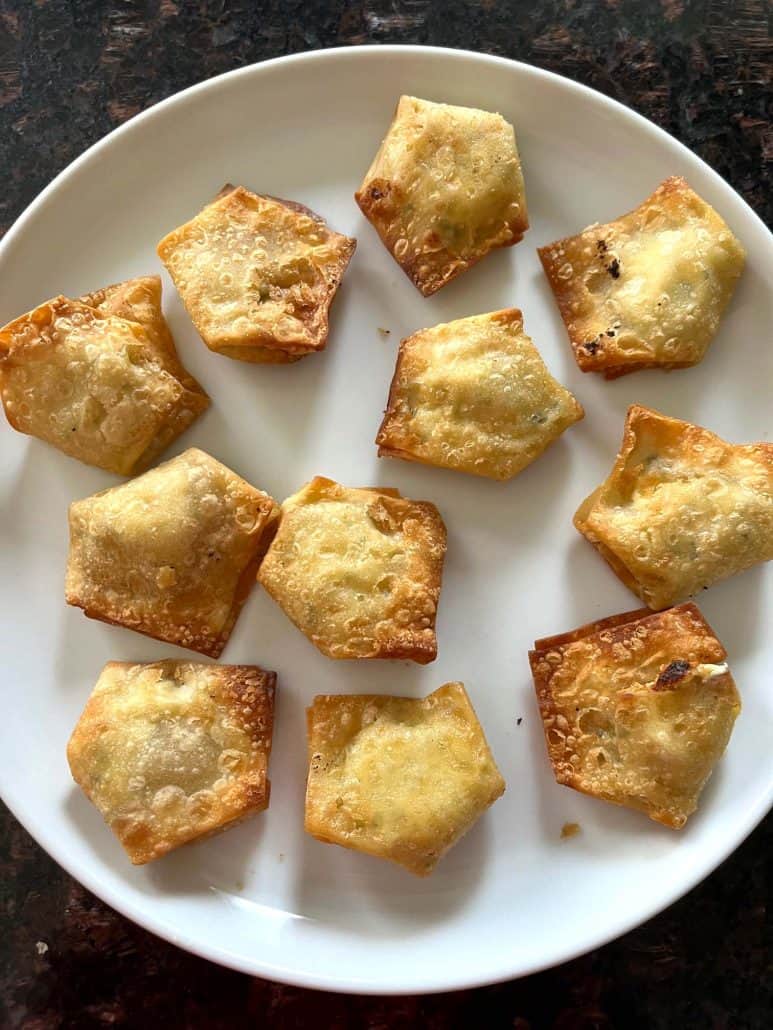 Crispy air-fried Trader Joe’s jalapeño cream cheese wontons served on a white plate, ready to enjoy as a quick and tasty appetizer.
