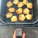 Crispy Trader Joe’s jalapeño cream cheese wontons freshly cooked in the air fryer basket, ready to serve as a quick and easy appetizer.