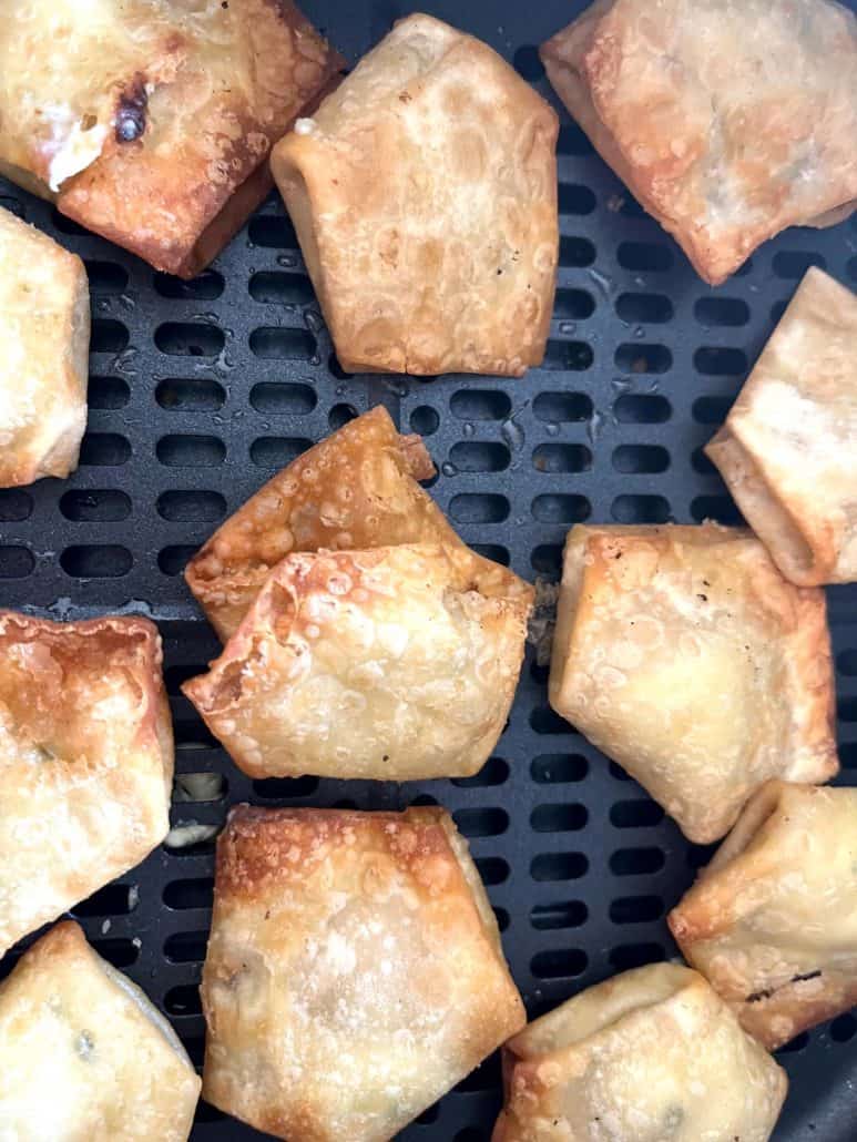 Close-up shot of crispy air-fried Trader Joe’s wontons inside the basket, showing their golden brown texture.