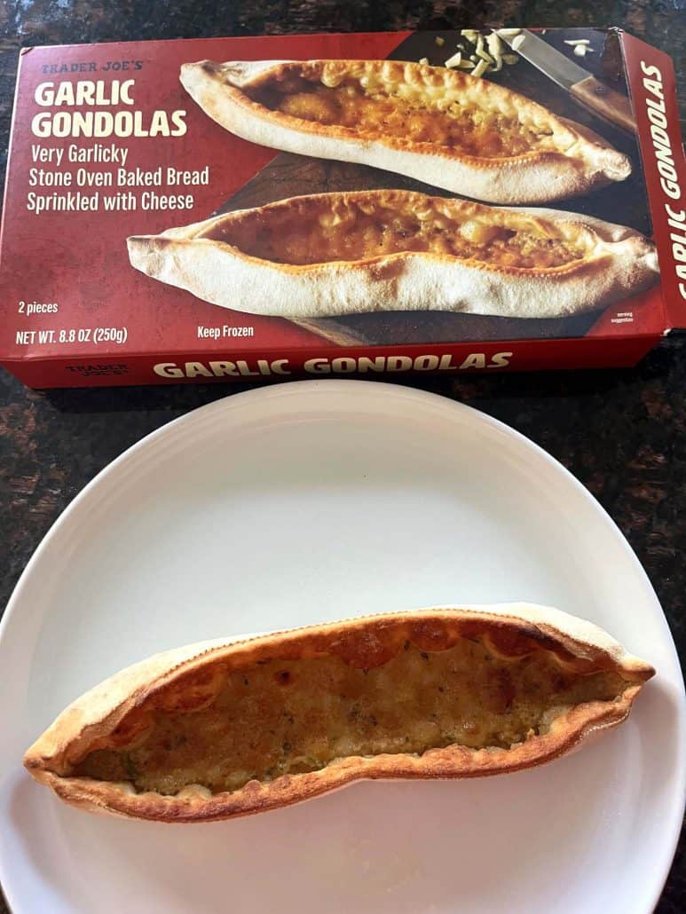 Cooked Trader Joe’s Garlic Gondola served on a white plate with the product box in the background.