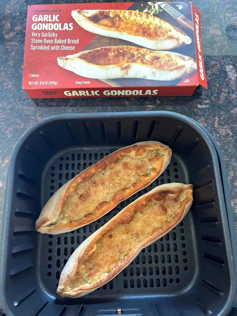 Trader Joe’s Garlic Gondolas box displayed above the air fryer basket containing two freshly cooked gondolas, highlighting the product and final result.