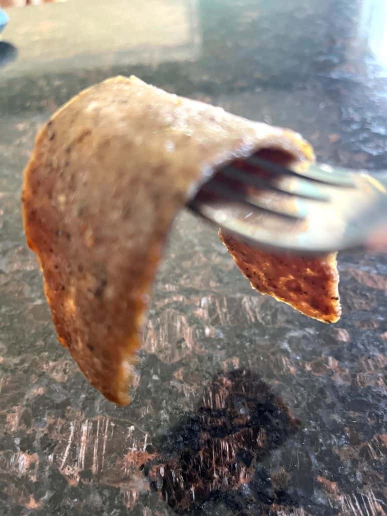 Close-up of a crispy edge on an air-fried Trader Joe’s gyro slice held up on a fork.