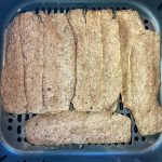 Close-up of Trader Joe’s gyro slices arranged in an air fryer basket before cooking.