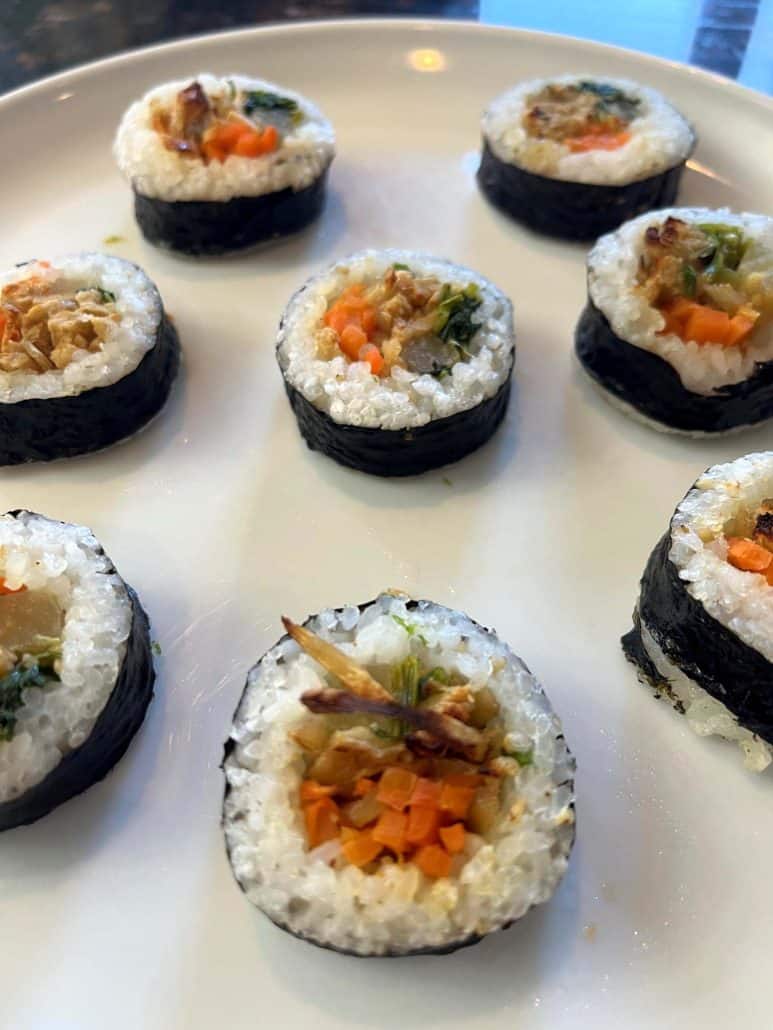 Cooked Trader Joe's kimbap rolls on a plate, showcasing the filling and texture.