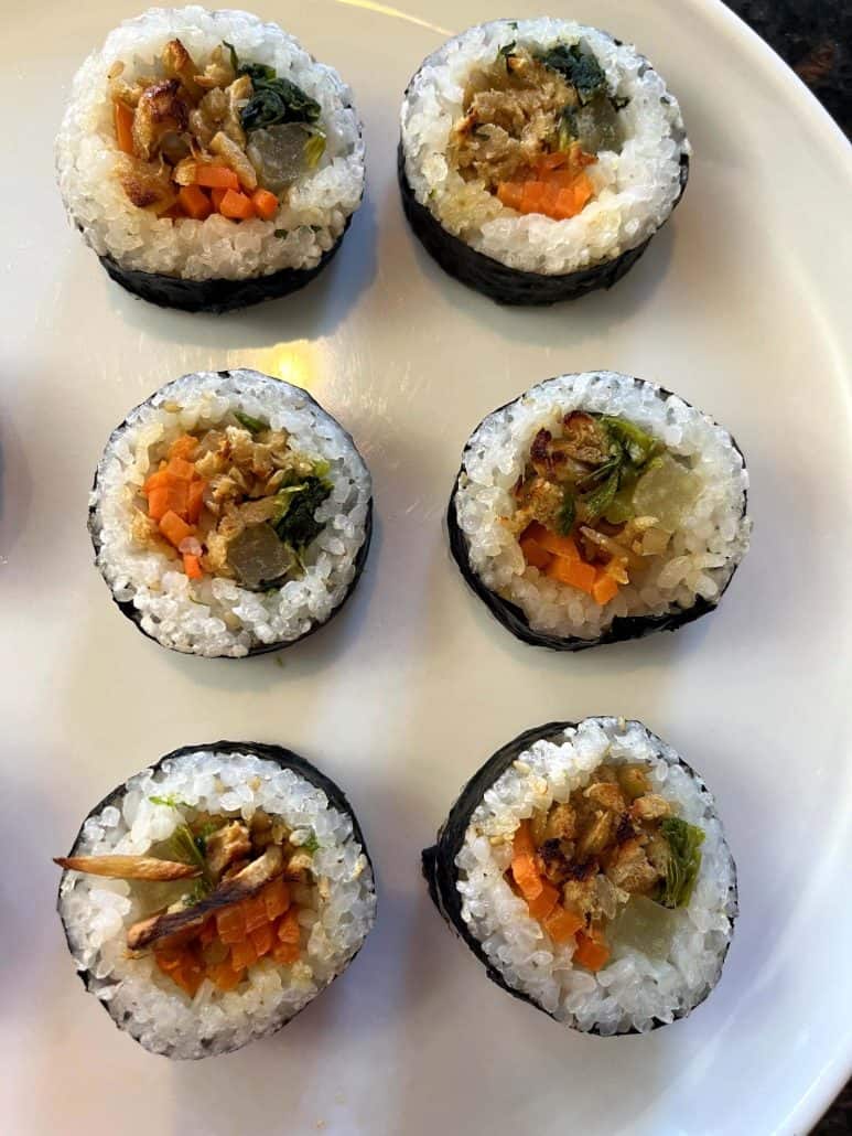 Cooked Trader Joe's kimbap rolls on a plate, highlighting the filling and texture of the rolls.