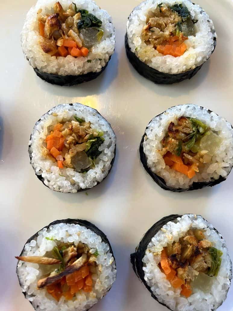 Plate of cooked Trader Joe's kimbap rolls, neatly arranged to show off the filling and rice texture.