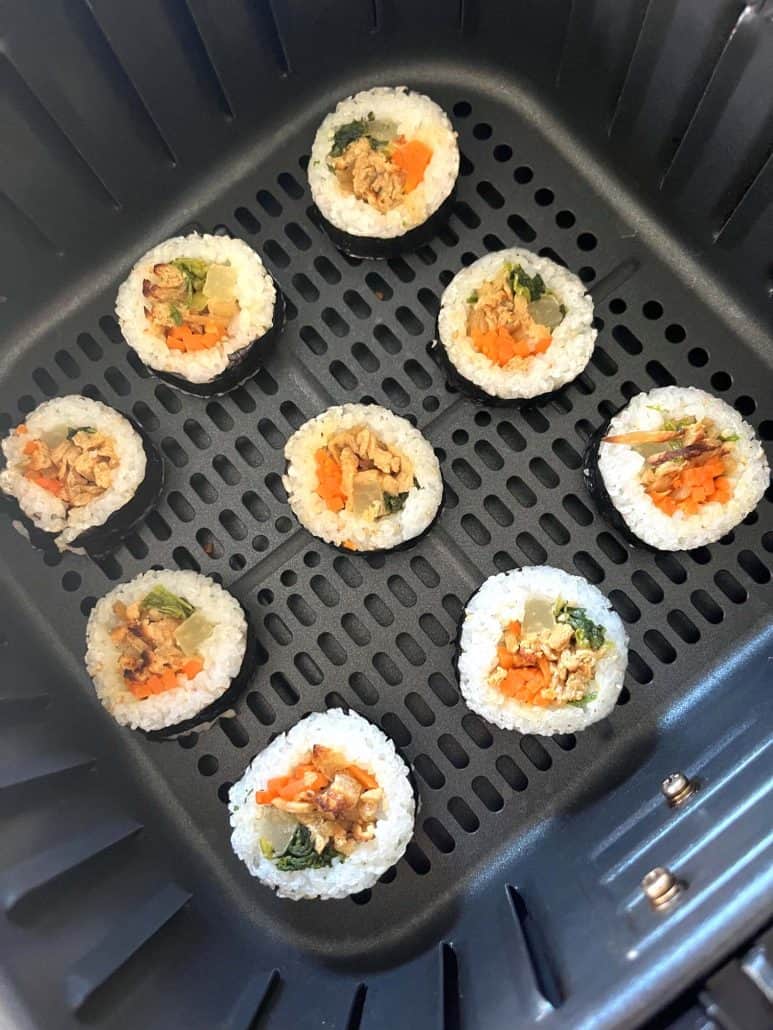 Trader Joe's frozen kimbap arranged in an air fryer basket.