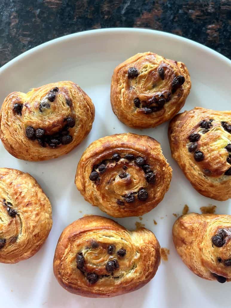 Freshly baked Trader Joe’s Mini Croissants on a plate, showing their golden-brown color and melted chocolate chips.