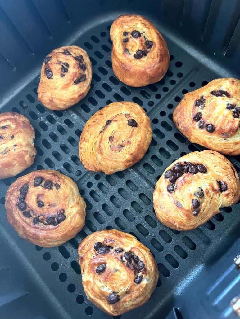 Golden-brown Trader Joe’s Mini Croissants in the air fryer basket, perfectly baked with melted chocolate chips.