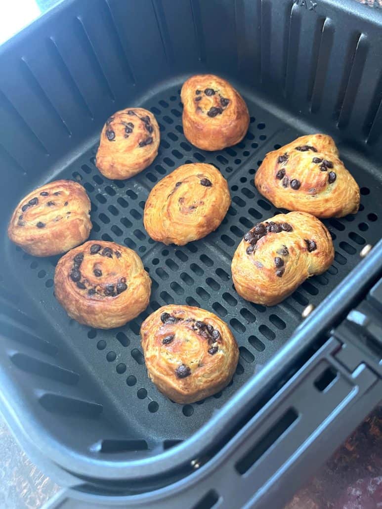 Air fryer basket with perfectly baked Trader Joe’s Mini Croissants.