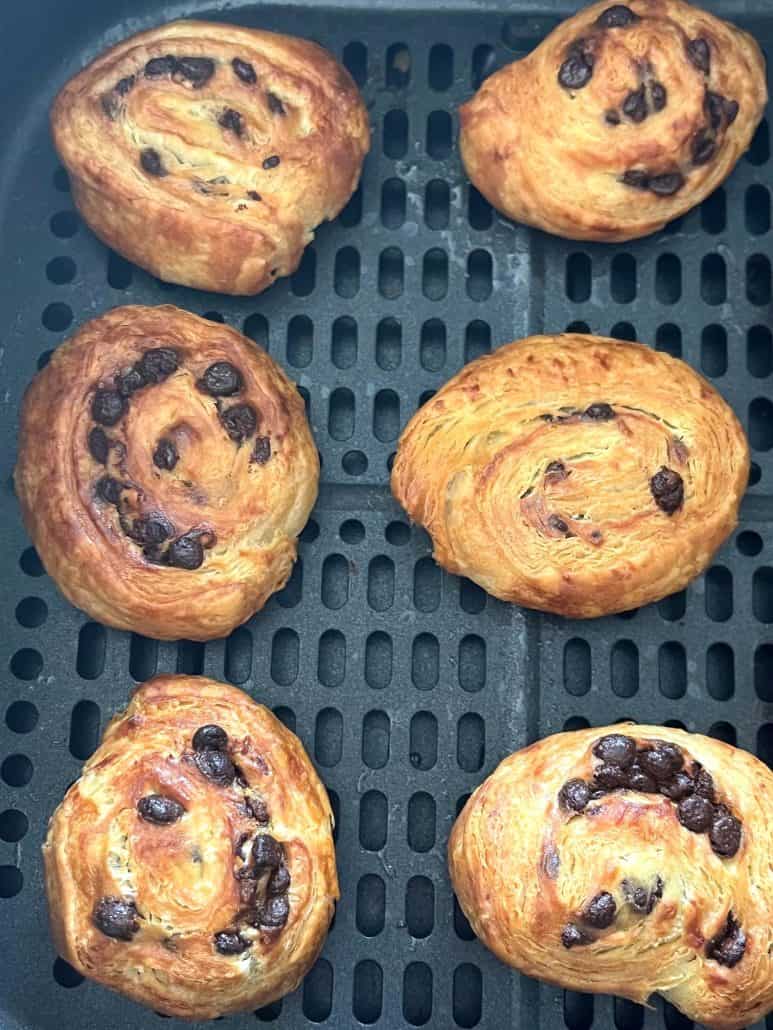 Air fryer basket with six perfectly baked Trader Joe’s Mini Croissants.