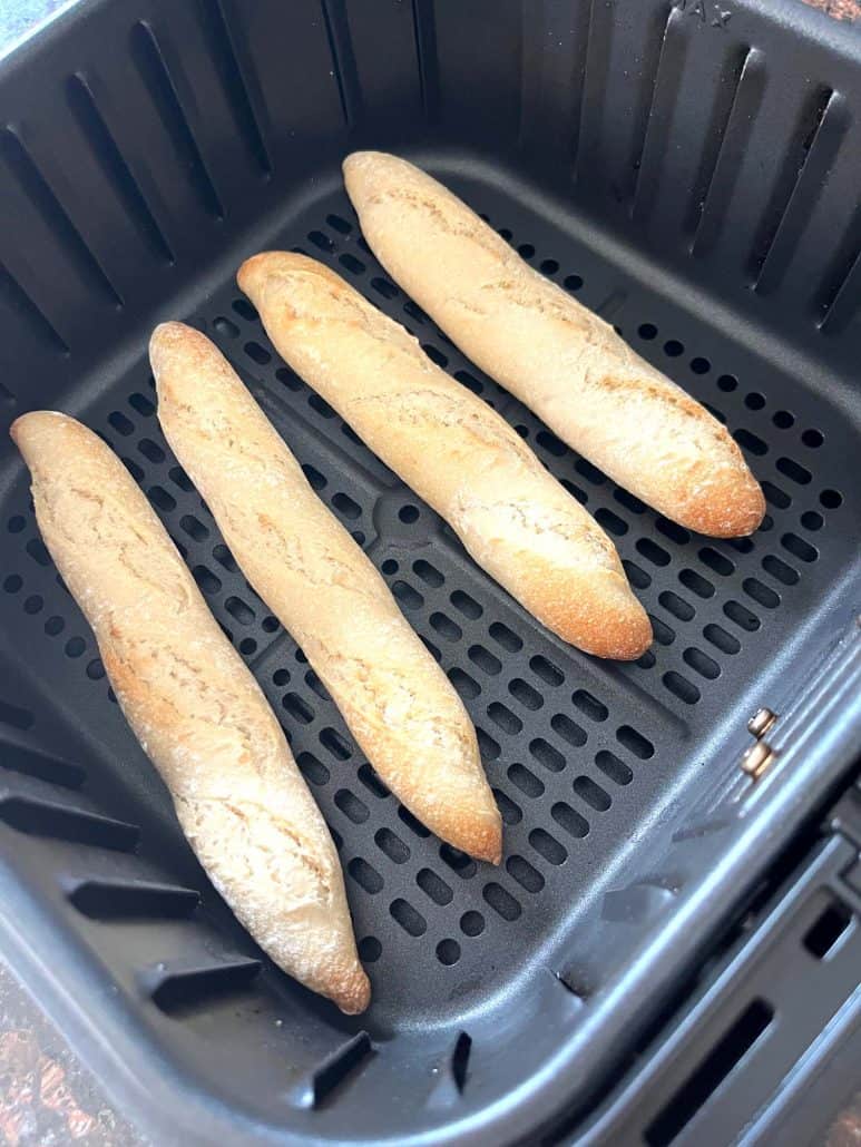 Golden-brown Trader Joe’s mini French baguettes cooked in the air fryer, shown hot and ready to enjoy.