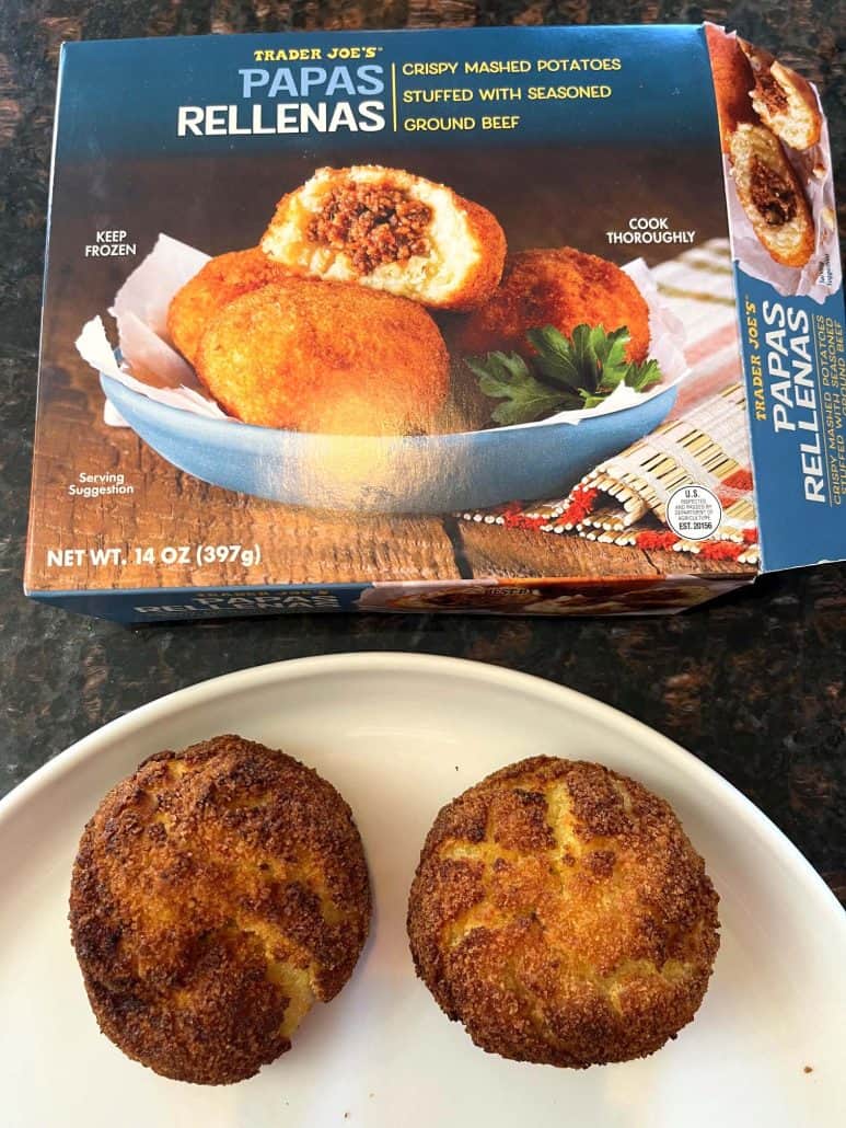 Cooked Trader Joe’s Papas Rellenas served on a plate with the product box in the background.