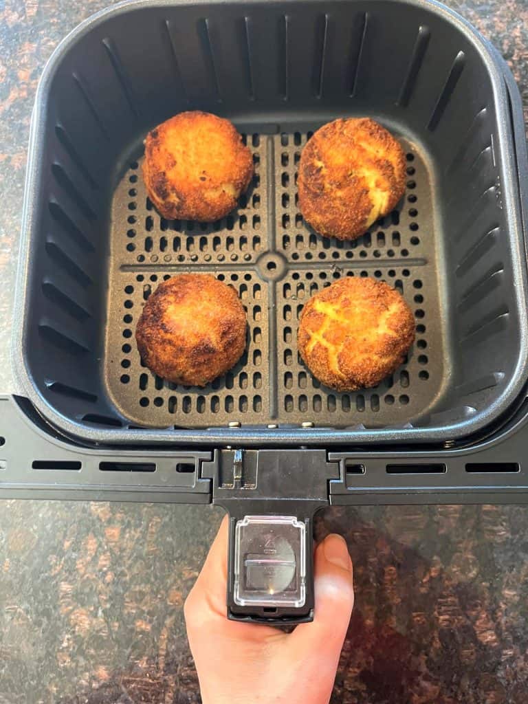 Trader Joe’s Papas Rellenas cooking in the air fryer basket until golden and crispy.