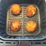 Four crispy Trader Joe’s Papas Rellenas cooked in an air fryer basket, ready to serve.