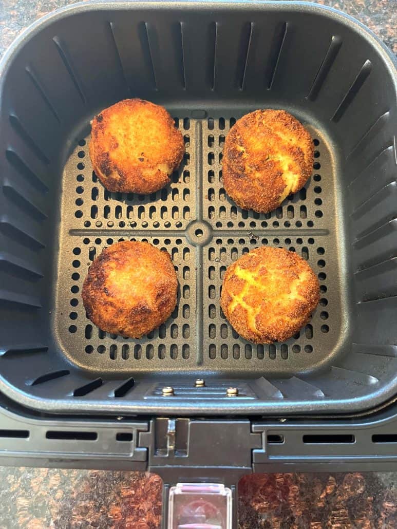 Four crispy Trader Joe’s Papas Rellenas cooked in an air fryer basket, ready to serve.