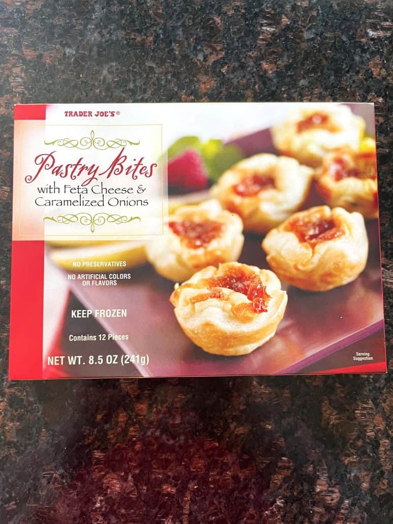 Box of Trader Joe’s Pastry Bites with feta cheese and caramelized onions.