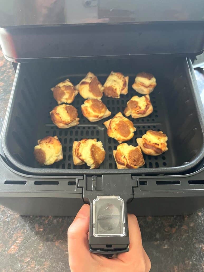 Air fryer basket filled with golden brown Trader Joe’s Pastry Bites just after cooking.