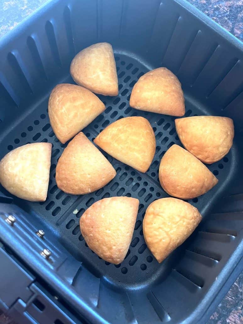 Golden brown Trader Joe’s Panzerotti Pizza Bites arranged in a single layer inside the air fryer basket—crispy and ready to serve using the air fryer method.