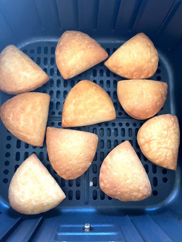Crispy, golden Trader Joe’s Panzerotti Pizza Bites in the air fryer basket after cooking.