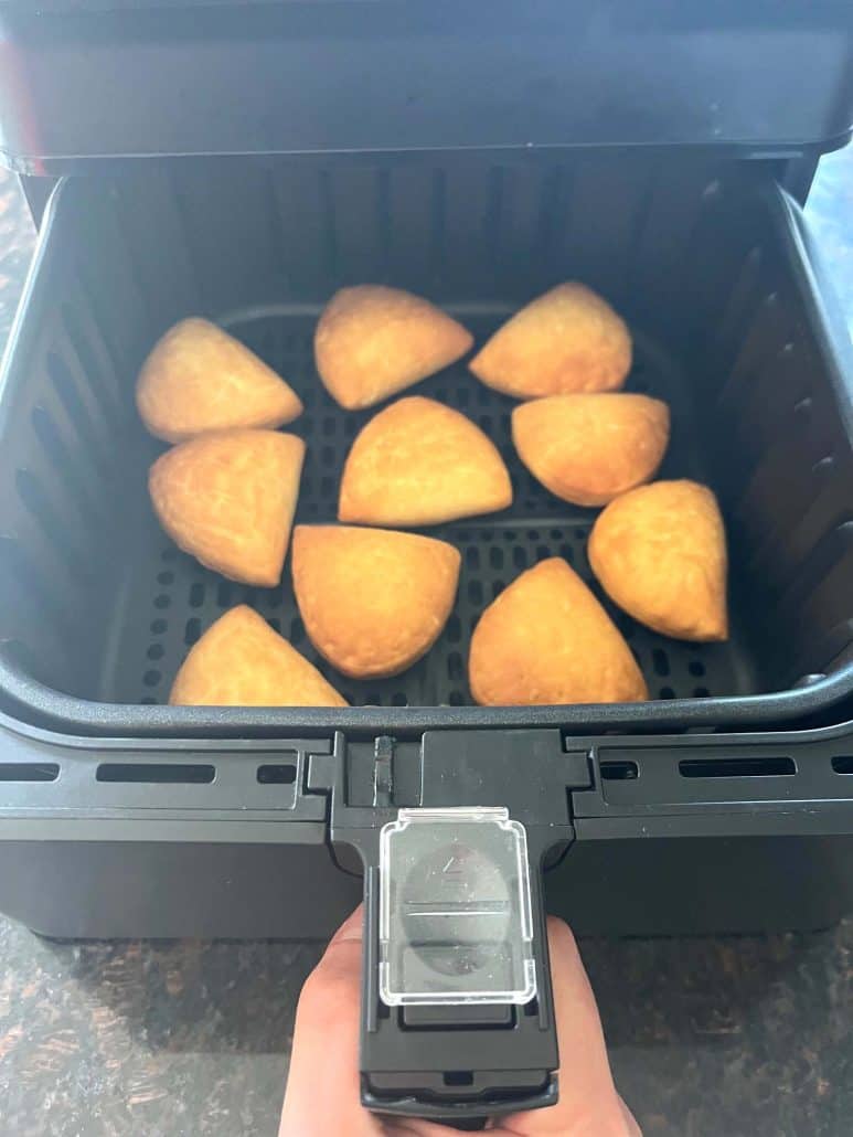 Trader Joe’s Panzerotti Pizza Bites shown crispy and golden inside the air fryer basket.