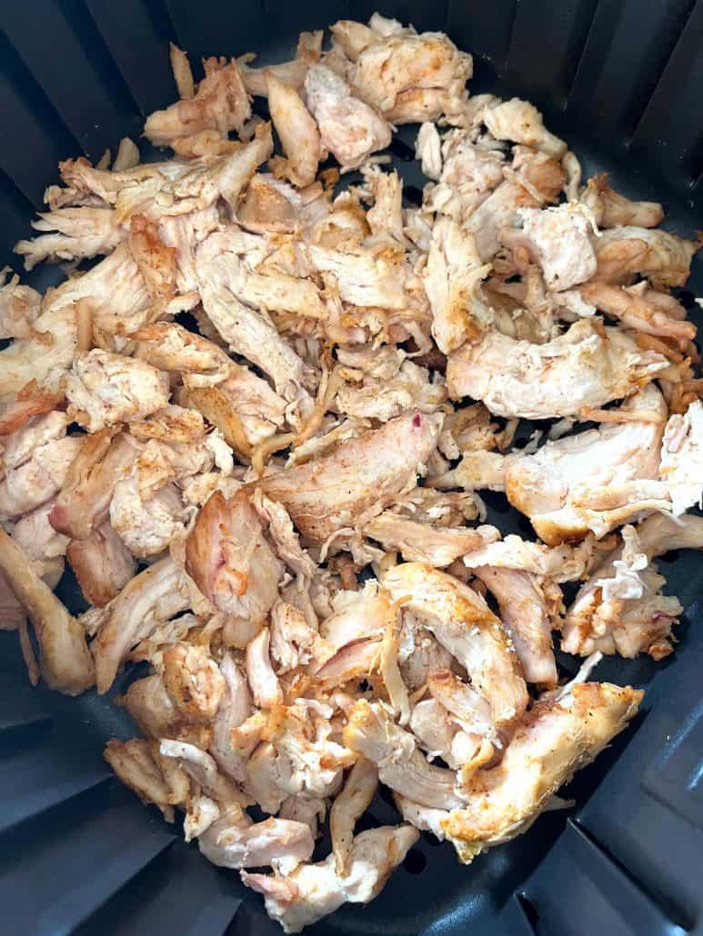 Golden brown pulled chicken from Trader Joe’s shown crisped to perfection in the air fryer basket.
