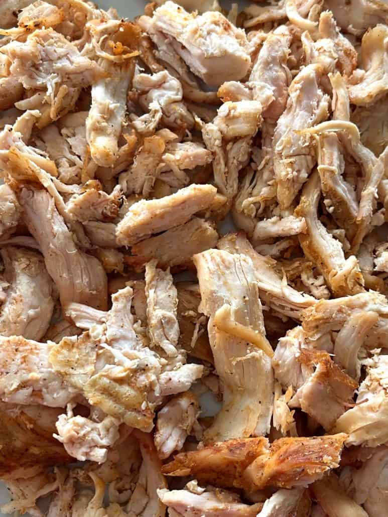 Extreme close-up of air-fried Trader Joe’s pulled chicken, showing juicy texture and crispy browned edges.