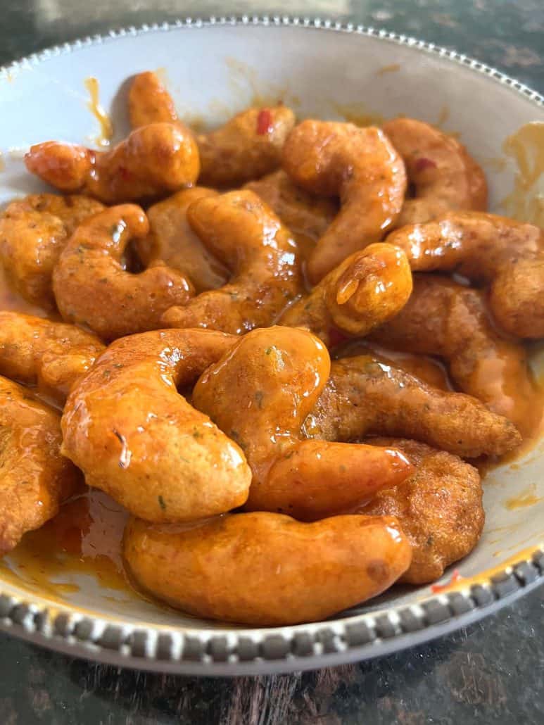 Angled view of Trader Joe’s Shrimp Boom Bah in a bowl, coated with sweet and spicy sauce after air frying.
