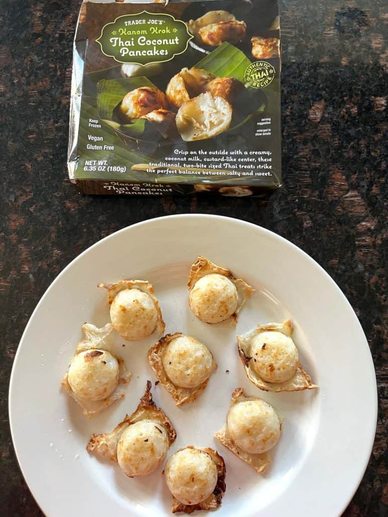 Cooked Trader Joe’s Thai Coconut Pancakes (Kanom Krok) served on a white plate with the product box displayed above—ready to enjoy this easy air fryer dessert.
