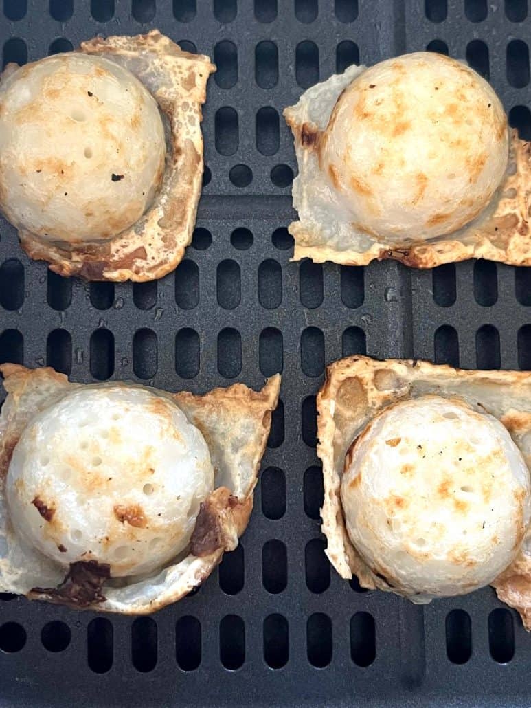 Extreme close-up of air-fried Trader Joe’s Thai Coconut Pancakes (Kanom Krok), highlighting their golden tops and crispy edges—freshly cooked and ready to enjoy.