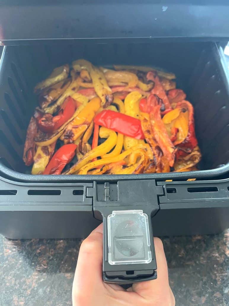 Freshly air-fried tri-color bell pepper strips in a black air fryer basket—bright, tender, and ready to enjoy.